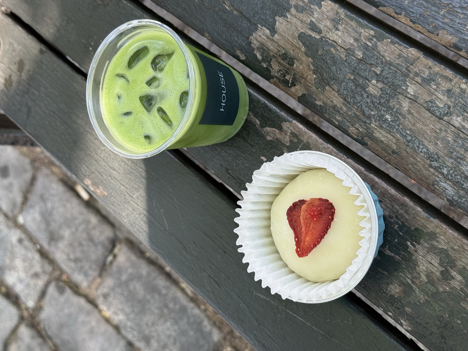 An iced matcha and a strawberry mochi