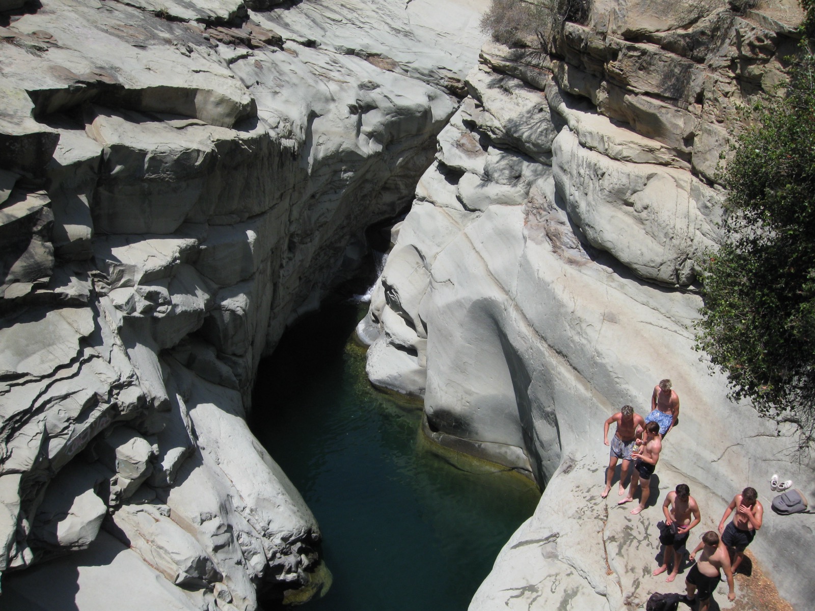 A canyon swimming hole surrounded by white rock