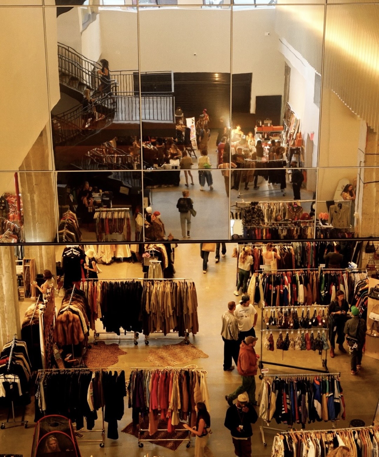 Racks of vintage clothing at a thrift market